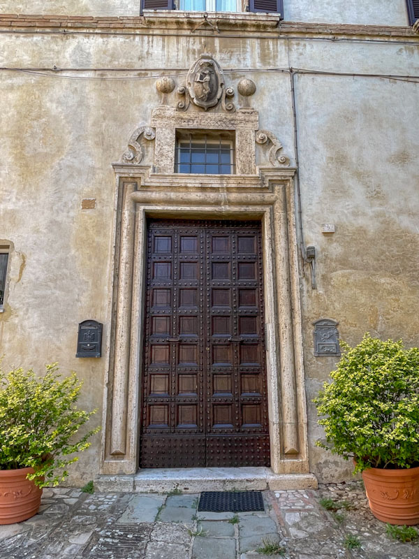 Grand carved wooden panelled door, Todi, Umbria, Italy, July 2023