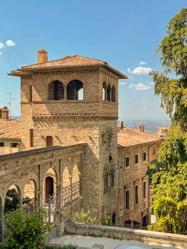 A classic urban Umbrian view, complete with a door through the arches, Todi, Umbria, Italy, July 2023