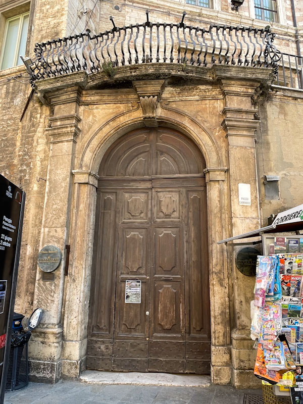 Door and balcony above, Perugia, Umbria, Italy, July 2023