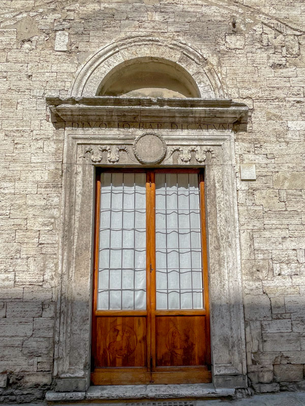 Ancient stonework surrounds a modern door, Perugia, Umbria, Italy, July 2023
