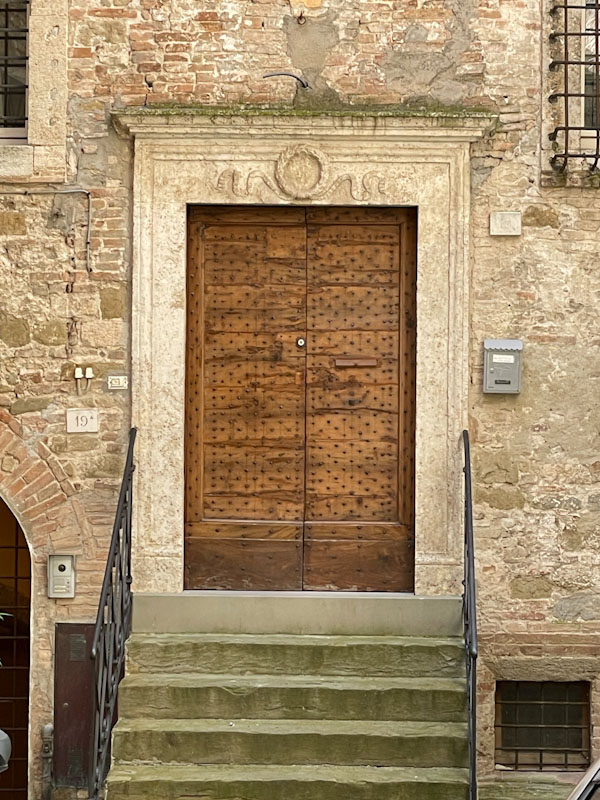 Stunning studded door and stylish stone surround, Perugia, Umbria, Italy, July 2023