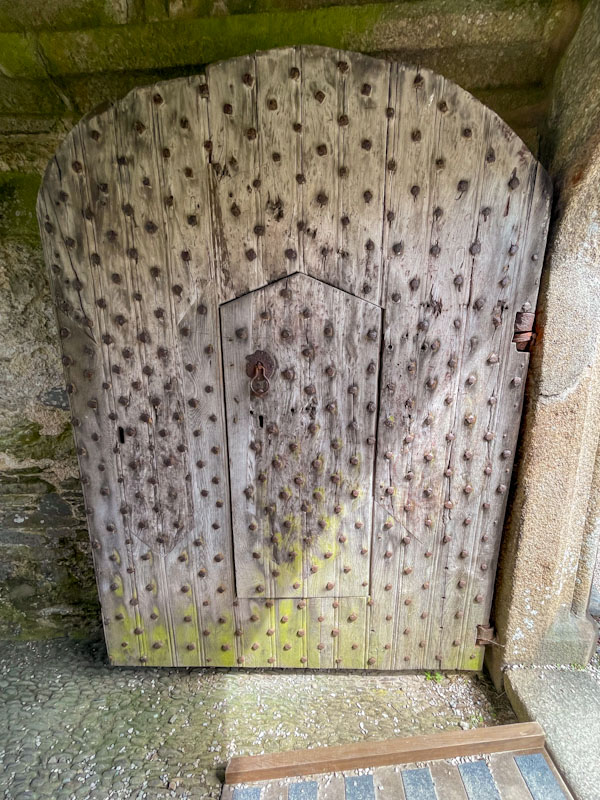 Ancient studded door within a door, Cotehele, Calstock, Cornwall, August 2023