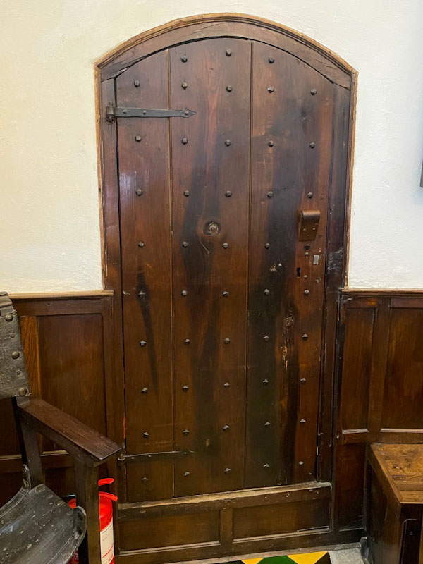 Studded door with interesting door furniture an fittings, Cotehele, Cornwall, August 2023
