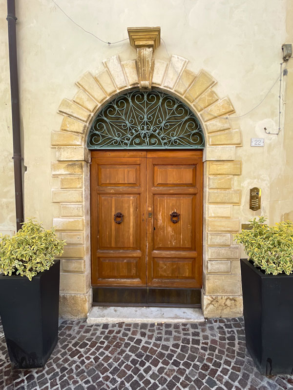 Fine door with ironwork fan, Montefalco, Umbria, Italy, July 2023