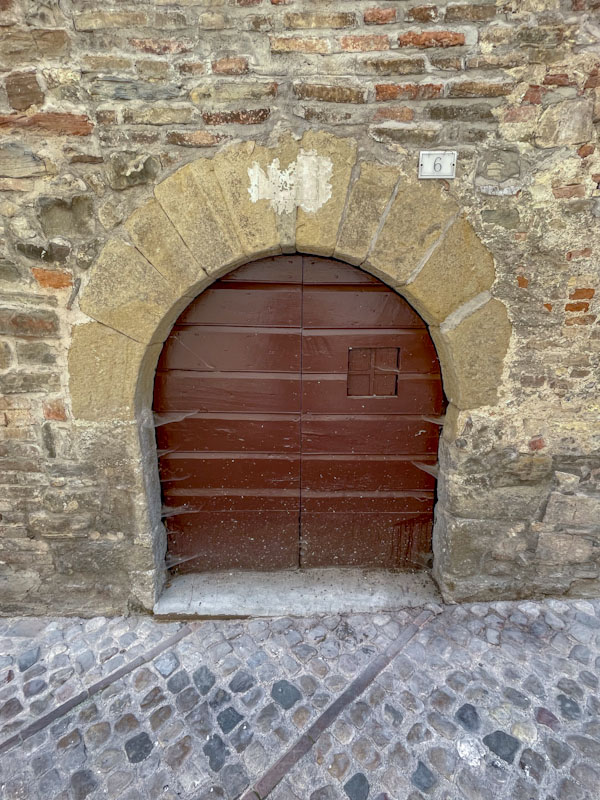 Low arched door, Montefalco, Umbria, Italy, July 2024