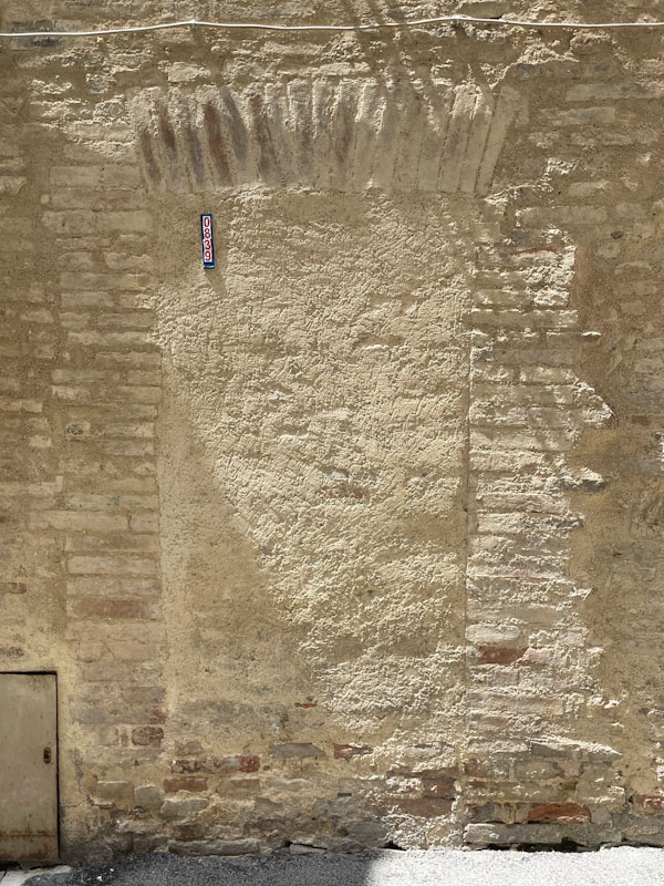Barely visible ghost door, Montefalco, Umbria, Italy, July 2024