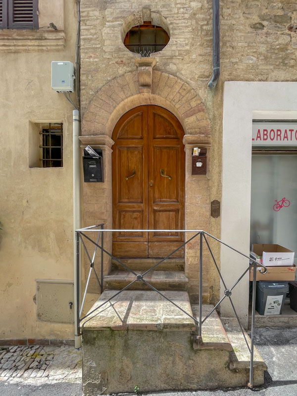Arched door and steps, Montefalco, Umbria, Italy, July 2024