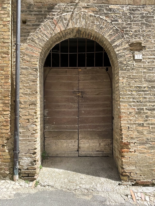 Well-used and weathered doors, Montefalco, Umbria, Italy, July 2024