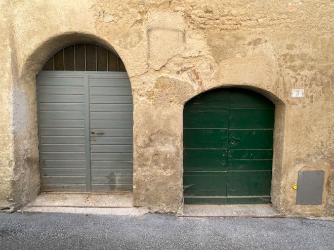 A pair of utilitarian doors, Montefalco, Umbria, Italy, July 2024