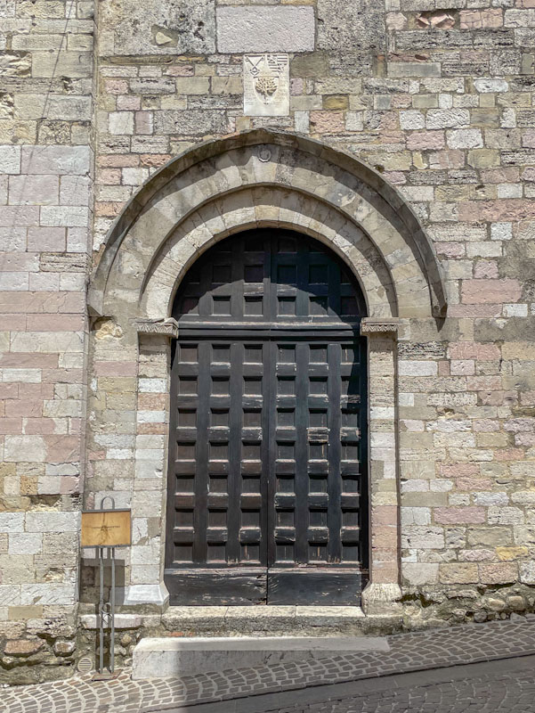 Wonderful panelled arched door, Montefalco, Umbria, Italy, July 2024