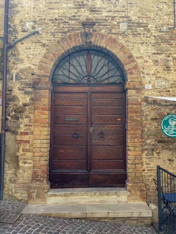 A fine arched door, Montefalco, Umbria, Italy, July 2024
