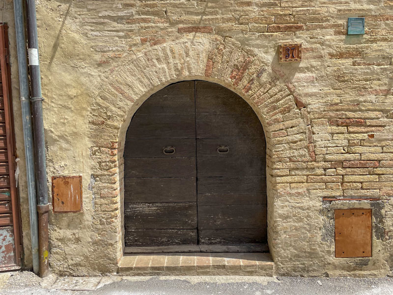 Small, double door arch, Montefalco, Umbria, Italy, July 2023
