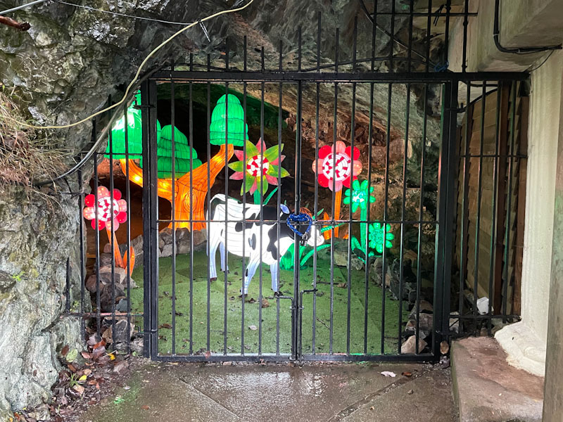 Gate into a winter attraction cave, Cheddar Gorge, Somerset, October 2023
