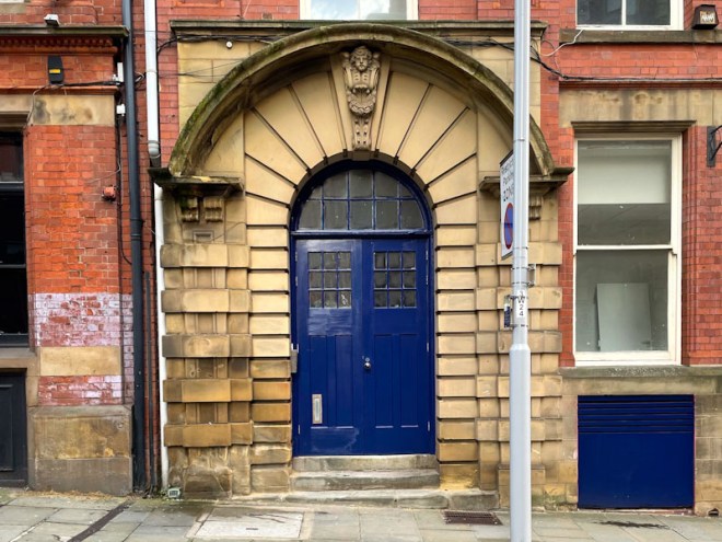 Wide stone entrance and blue doors, Nottingham, November 2023