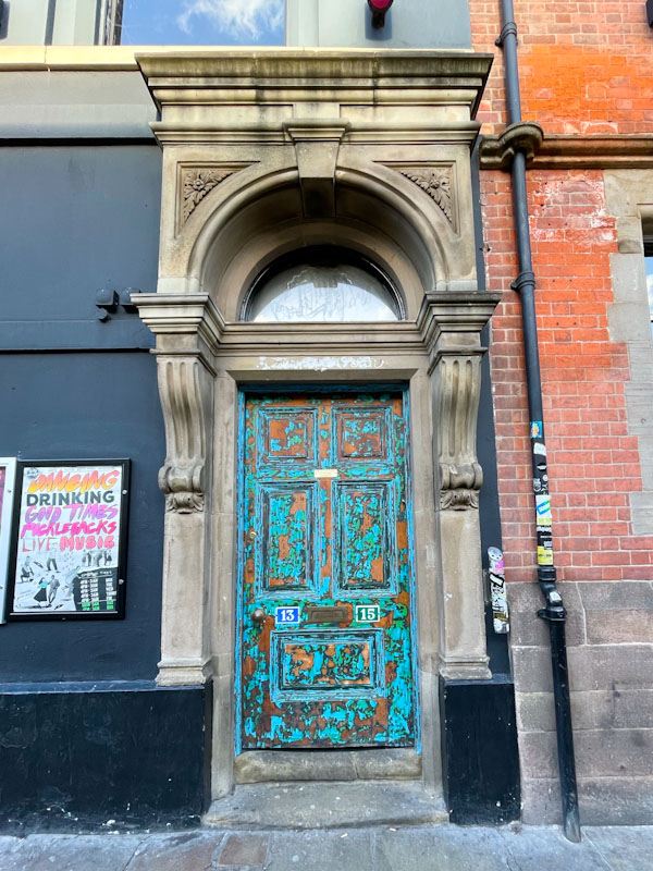 Peeled paint on a door creating a patina effect, Nottingham, November 2023