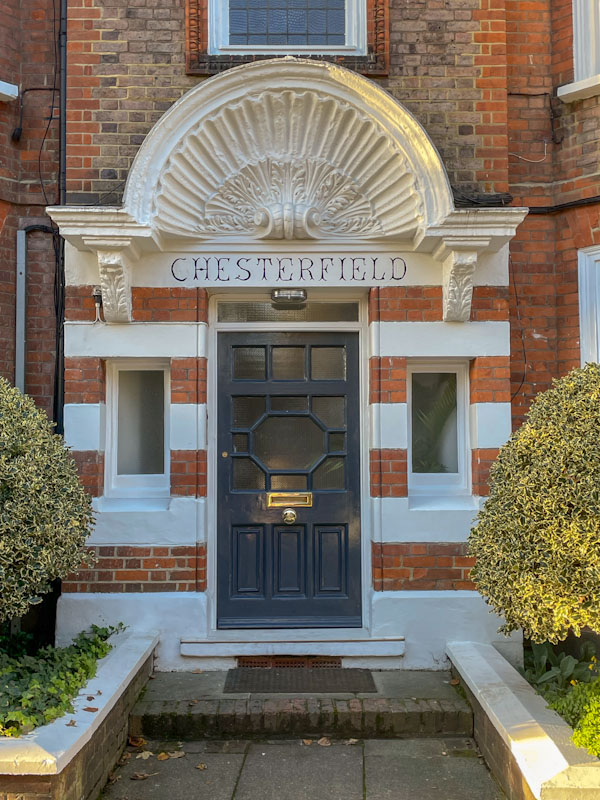 Chesterfield door and fine scalloped awning, Highgate, London, November 2023