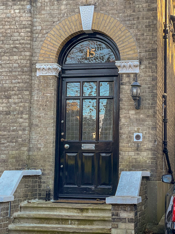 Triple panelled black door, Highgate, London, November 2023