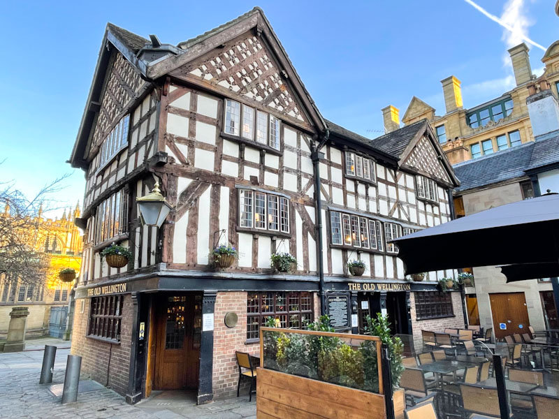 Entrance and doors to The Old Wellington pub, China Town, Manchester, November 2023