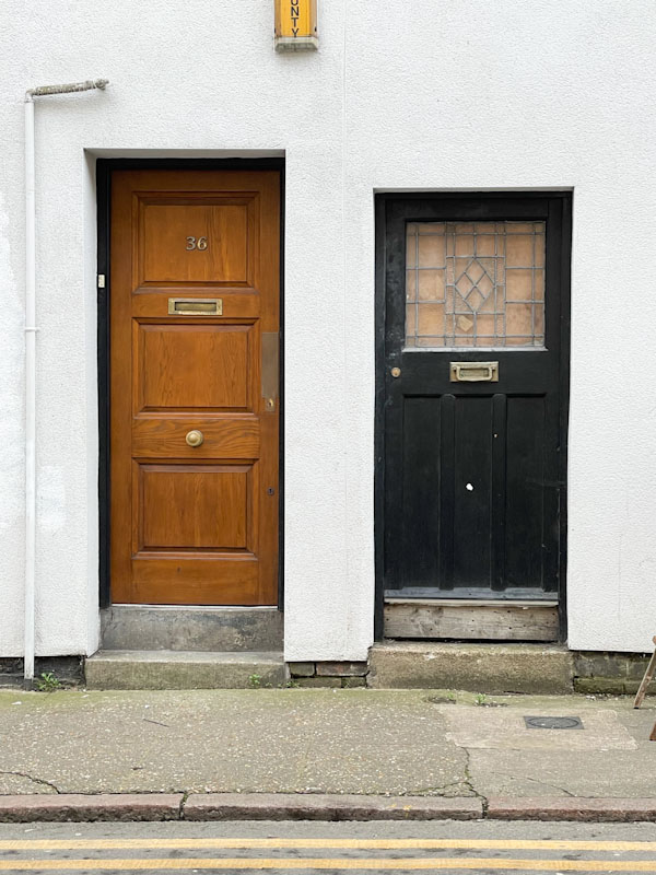 Neighbours with rather different doors, Nottingham, March 2024