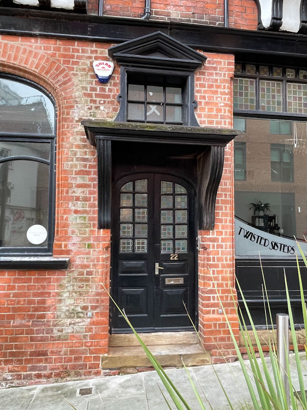 Black door with awning and incorporated window, Nottingham, March 2024
