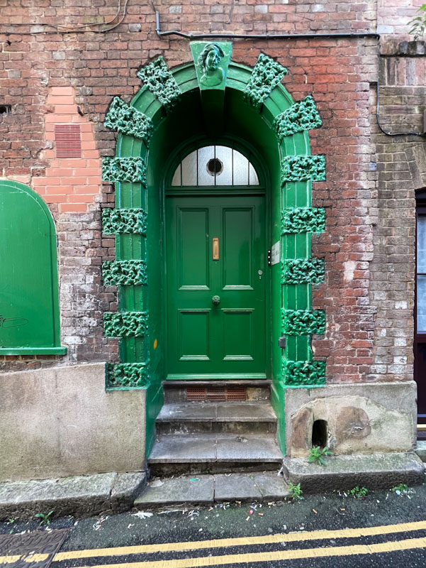 Grand green arched door, Exeter, October 2023