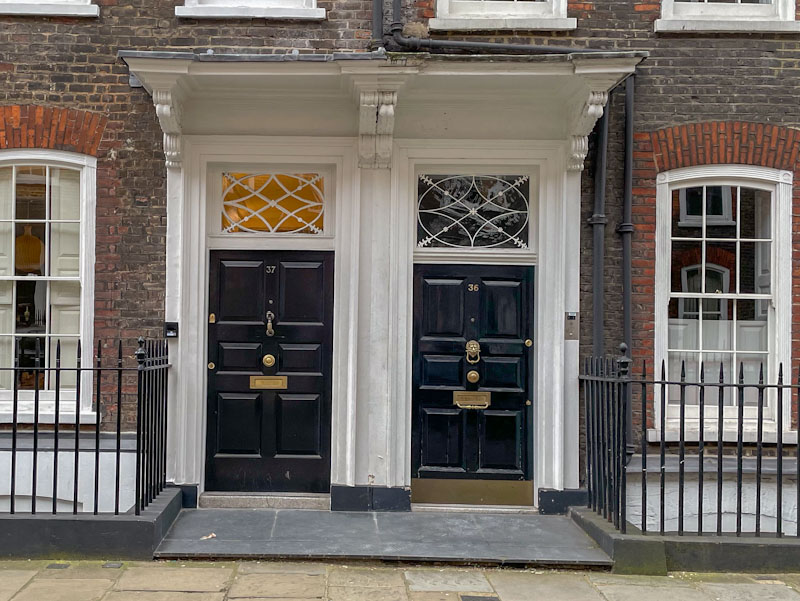Double set of next-door doors with attractive fanlights, Central London, March 2024