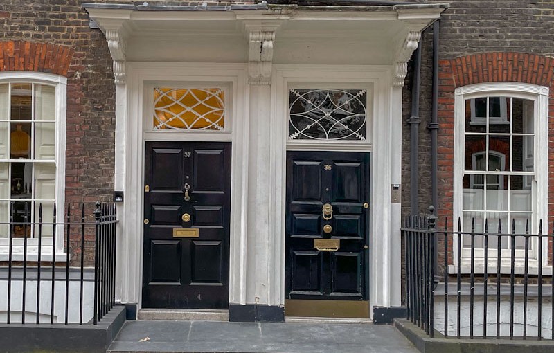 Double set of next-door doors with attractive fanlights, Central London, March 2024