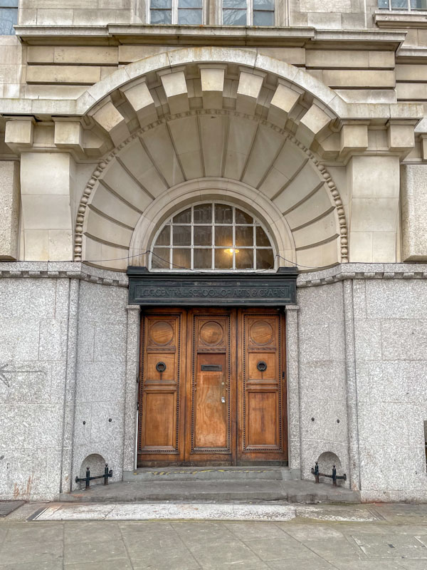 Grand three-door entrance with boot scrapers on either side, London, March 2024