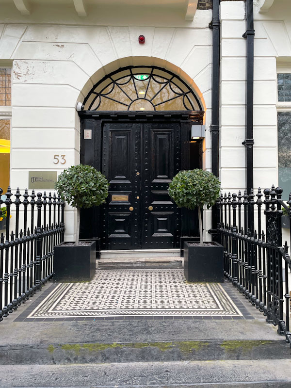 Strong black double doors with large fanlight and some great tiles , London, March 2024
