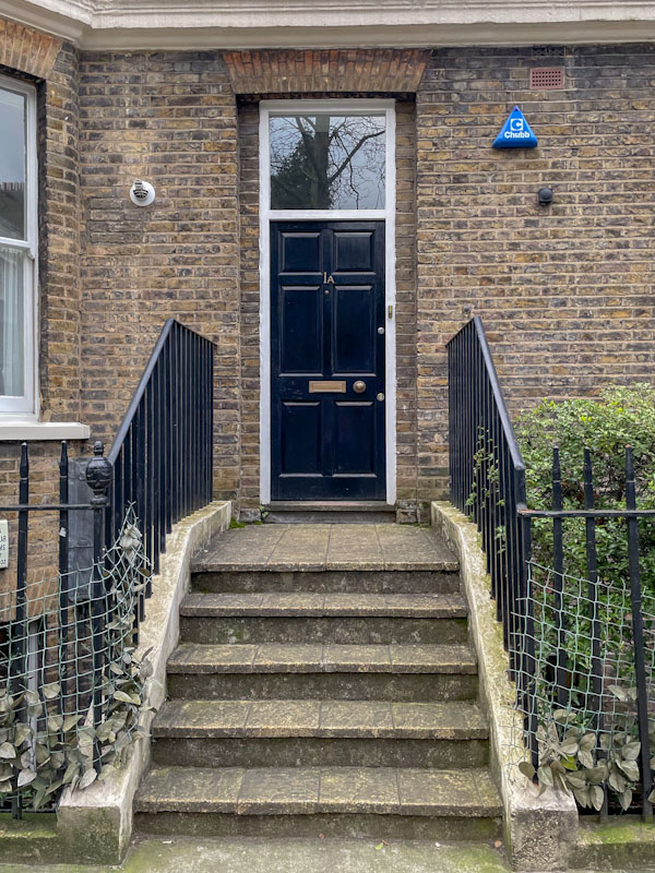 Black front door of my old home, 1A Montague Place, London, March 2024