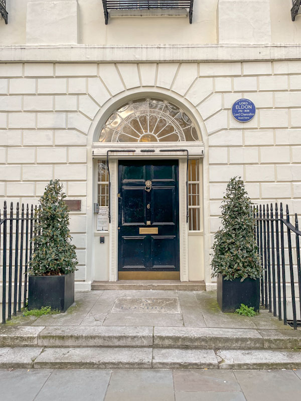 Large black door with a fine white surround and fan light, Lord Eldon (Lord Chancellor) lived here, London, March 2024