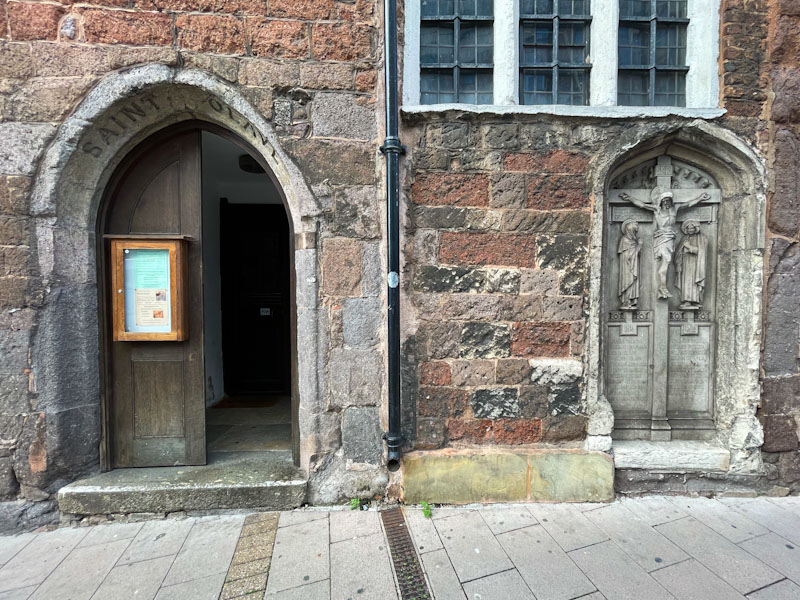 Church door with notice board, Exeter, October 2023