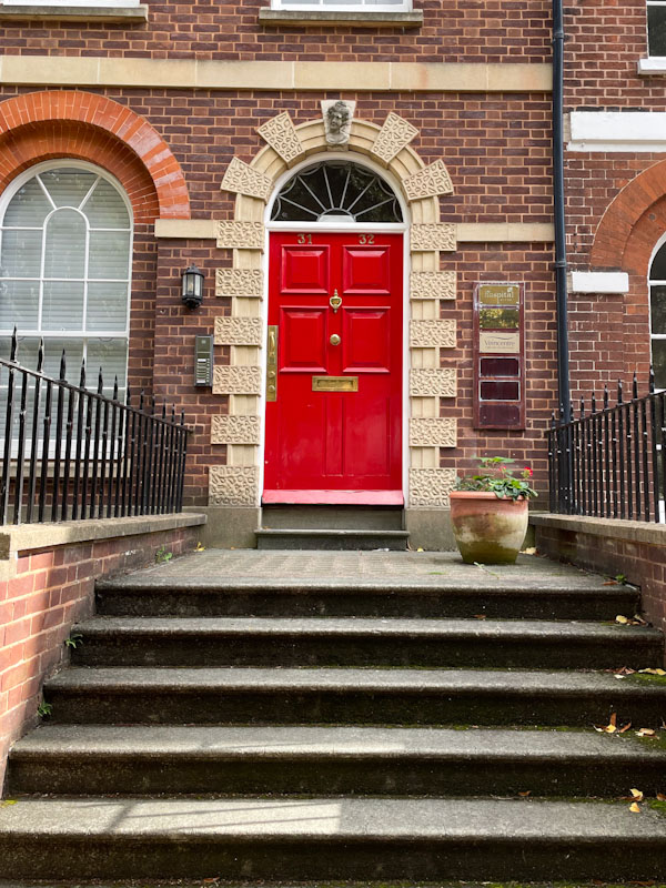 Red door at number 31 and 32, Exeter, Devon, October 2023