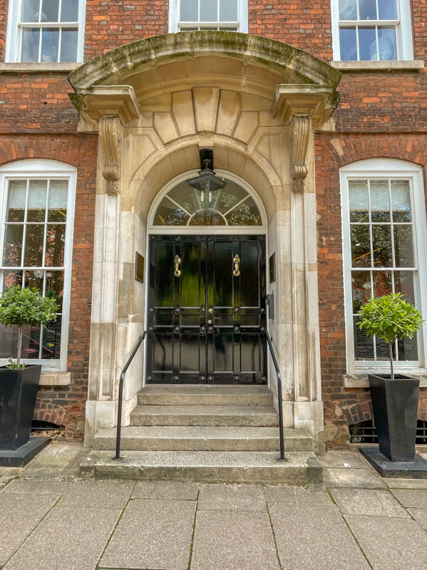 A fine set of double doors and a grand doorway, Exeter, Devon, October 2023