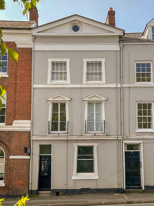 Two black doors, and curious trapezoid windows (reminiscent of the Egyptian House in Penzance), Exeter, Devon, October 2023