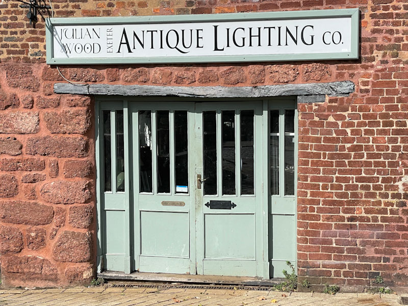 Shop doors and wonderful ancient lintel, Exeter, Devon, October 2023