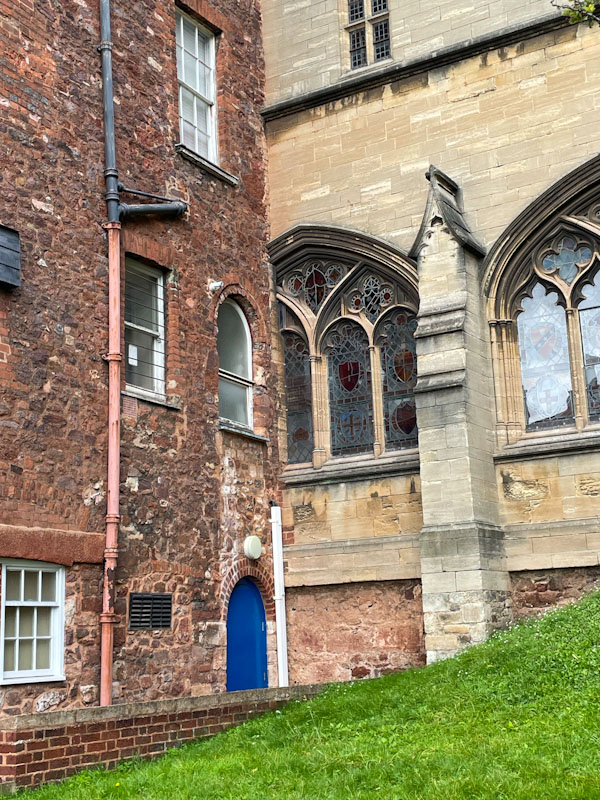 When two buildings collide - the view from inside the church must be a little odd. Blue door, Exeter, Devon, October 2023
