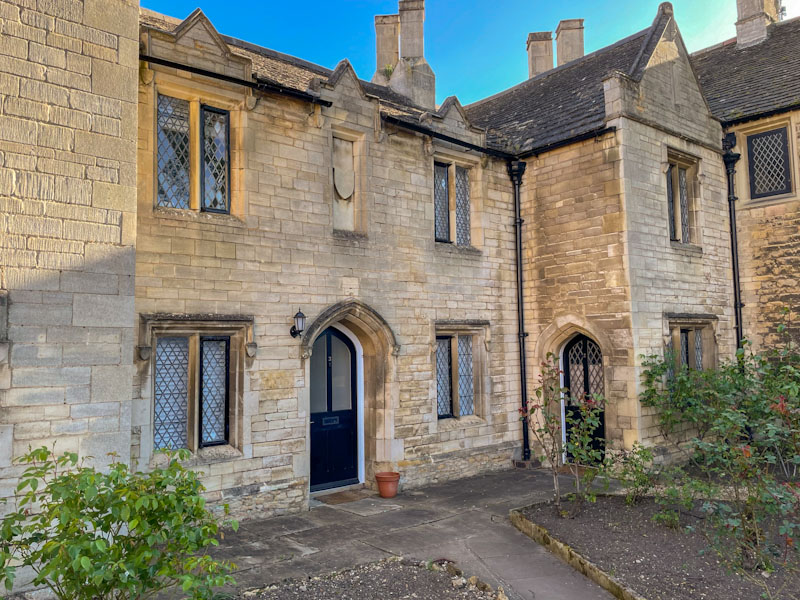 Two black arched doors in the grounds of the Cathedral, Peterborough, April 2024