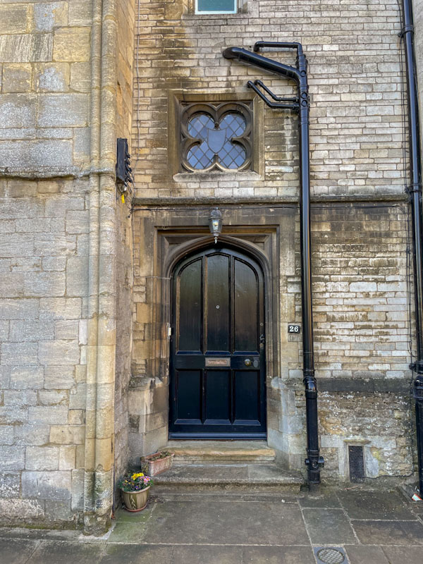 Black door, window and downpipe, Peterborough, Cambridgeshire, April 2024