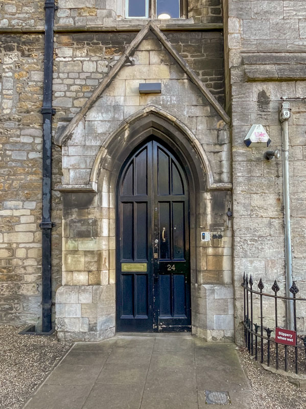 Black door at number 24 and be careful those flagstones can be slippery when wet, Peterborough, Cambridgeshire, April 2024