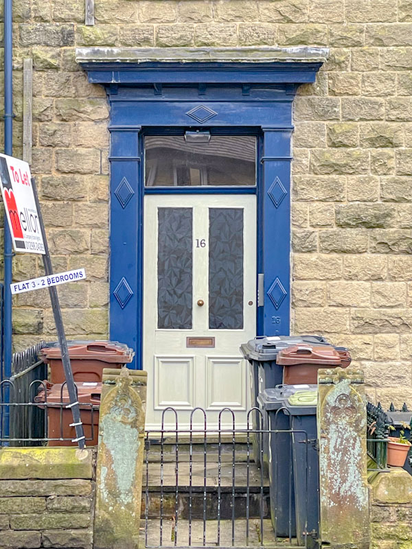 Diamond decorated door frame and white door, Buxton, Derbyshire, April 2024