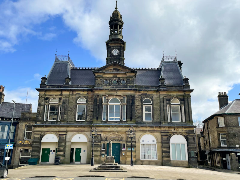 The faded grandeur of the Buxton town hall with several doors, Buxton, Derbyshire, April 2024