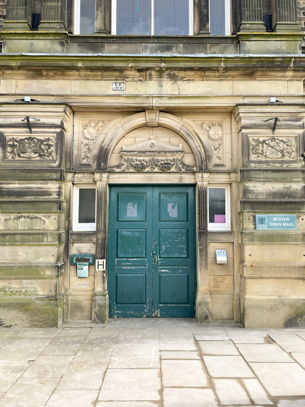 A worn out door on Buxton Town Hall, Buxton, Derbyshire, April 2024