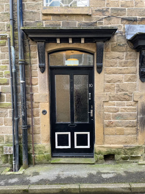 Black door at number 10, Buxton, Derbyshire, April 2024