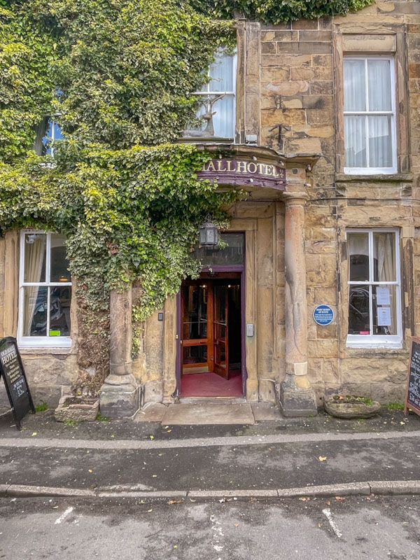 Rotating door and beautiful stone entrance to the Old Hall Hotel, Buxton, Derbyshire, April 2024