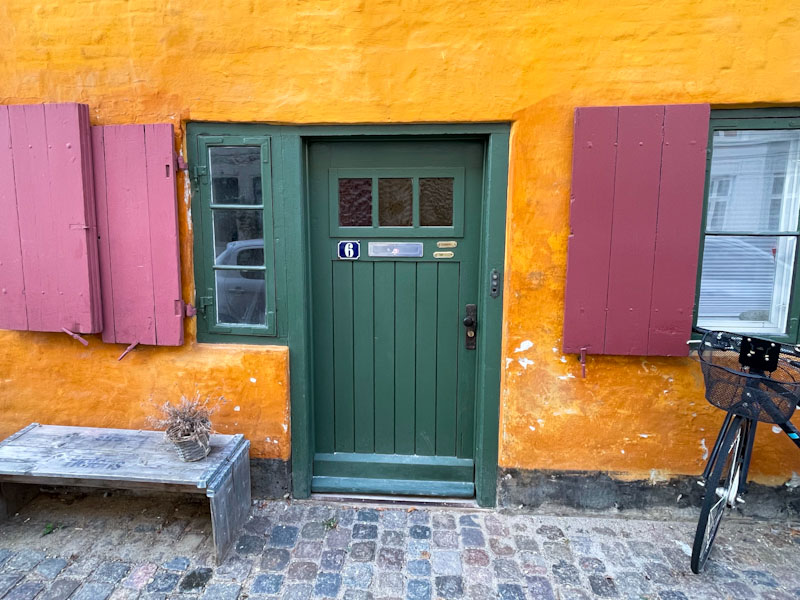 Green door and red shutters, Store Kongensgade, Copenhagen, Denmark, September 2024