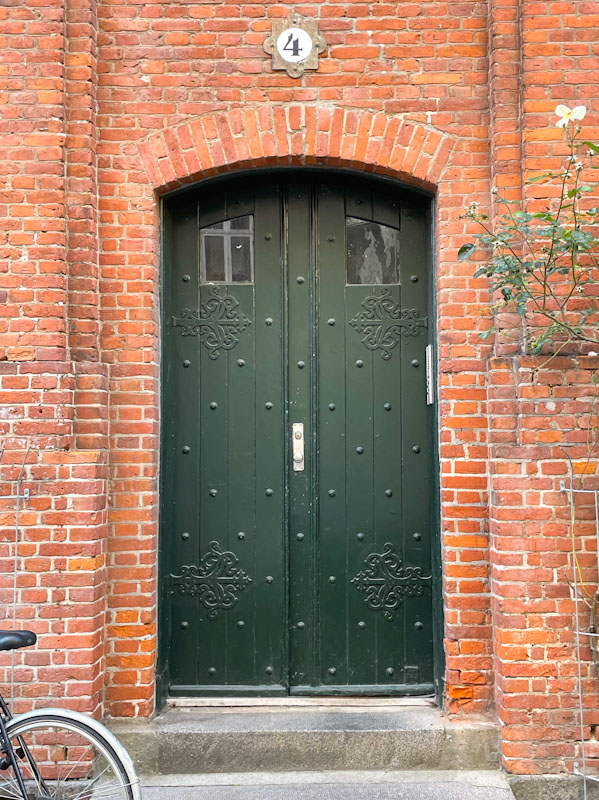 Green studded door, Wesselsgade, Copenhagen, September 2024