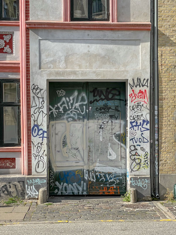 Heavily tagged doors Viktoriagade, Copenhagen, Denmark, September 2024