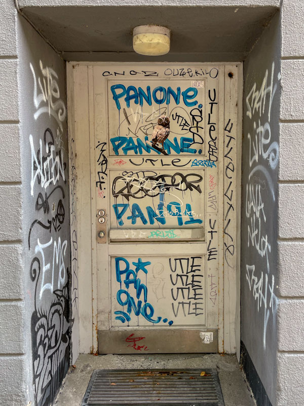 Tagged door with a rather nice owl in the middle, Amerikavej, Copenhagen, Denmark, September 2024