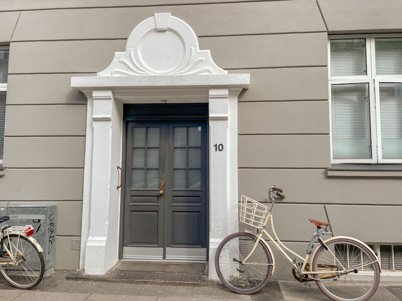 Double doors, bicycles and a fine surround, Sindshvilevej, Copenhagen, Denmark, September 2024